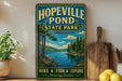 A vintage-style sign for Hopeville Pond State Park in Connecticut, featuring a scenic landscape with a lake, pine trees, and mountains.