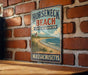 A vintage metal sign for Horseneck Beach State Reserve in Massachusetts, featuring a scenic beach and lighthouse illustration.