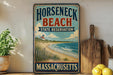 A vintage-style sign for Horseneck Beach State Reserve in Massachusetts, featuring a lighthouse and beach scene.
