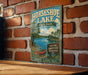 A vintage-style metal sign for Horseshoe Lake, Illinois, featuring a scenic illustration of the lake and surrounding nature.