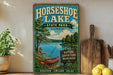 A vintage-style sign for Horseshoe Lake State Park in Illinois, featuring a scenic illustration of a lake surrounded by trees and a canoe.