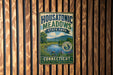 A metal sign with the text "Housatonic Meadows State Park" and "Connecticut" is displayed on a wooden wall.