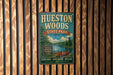 A vintage-style metal sign for Huesston Woods State Park in Ohio, featuring a canoe and a scenic landscape.