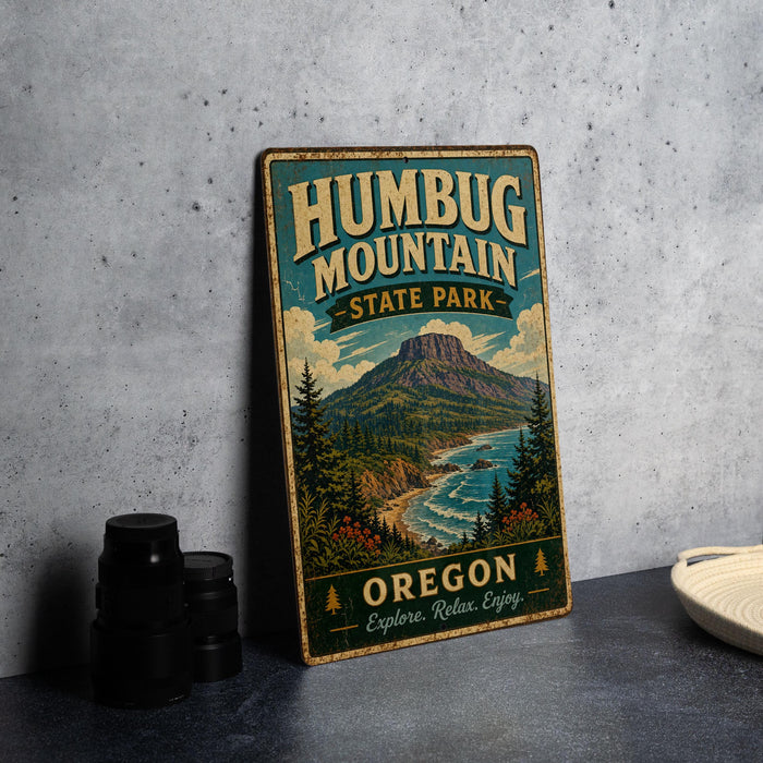 A vintage-style metal sign for Humbug Mountain State Park in Oregon, featuring a scenic mountain landscape and the text "Oregon Explore, Relax, Enjoy."