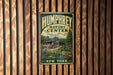 A vintage metal sign for the Humfrey Nature Center in New York, featuring an illustration of a pond, a bird, and a building surrounded by trees.