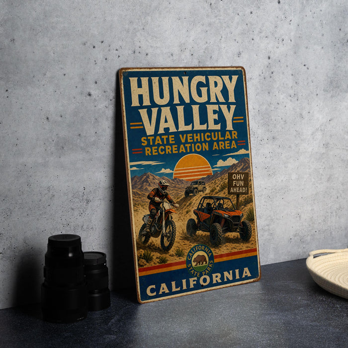 A vintage-style metal sign for the Hungry Valley State Vehicular Recreation Area in California, featuring an illustration of a person on a dirt bike and a jeep.