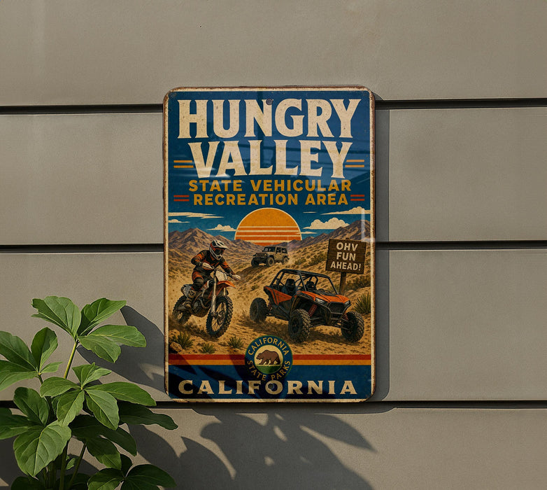 A vintage metal sign for the Hungry Valley State Vehicular Recreation Area in California, featuring an illustration of a person riding a dirt bike and a jeep.