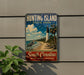 A vintage-style metal sign for Hunting Island State Park, featuring a lighthouse, palm trees, and a beach scene.