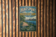 A vintage metal sign for Hunts Point Riverside Park in New York, featuring a scenic image of the park and a path leading to the water.