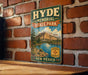 A vintage metal sign for Hyde Memorial State Park in New Mexico, featuring a scenic landscape with mountains, a lake, and a sign that says "New Mexico".
