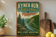 A vintage-style poster advertising Hyner Run State Park in Pennsylvania, featuring a scenic mountain landscape with a river and pine trees.