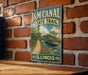 A vintage-style metal sign for the Illinois State Trail, featuring a scenic illustration of a canal and a bridge.