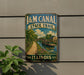 A vintage-style sign for the Illinois State Trail, featuring a scenic image of a canal and a bridge.