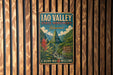 A vintage-style metal sign for the Iao Valley State Monument in Hawaii, featuring a mountainous landscape with a waterfall and tropical plants.