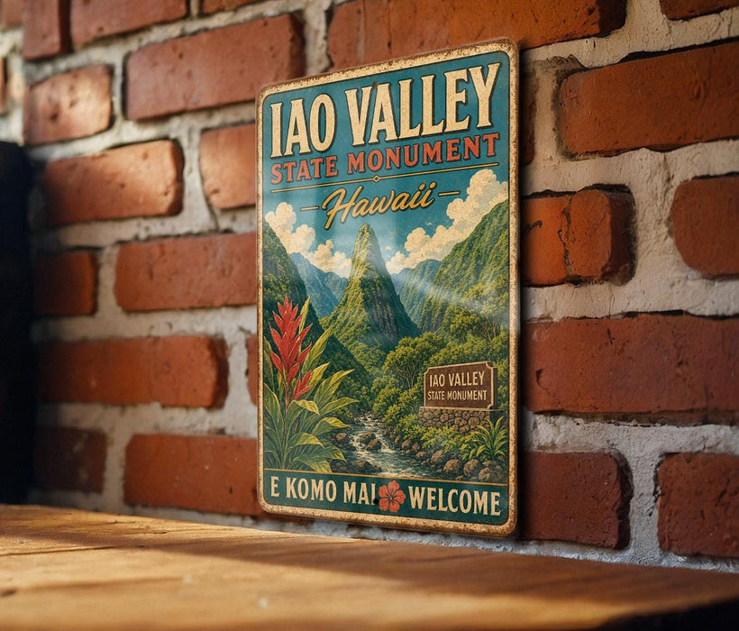 A vintage-style metal sign for the Iao Valley State Monument in Hawaii, featuring a mountain landscape with a waterfall and tropical plants.