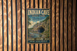 A vintage-style metal sign for Indian Cave State Park in Nebraska, featuring a scenic image of a cave surrounded by trees and a river.