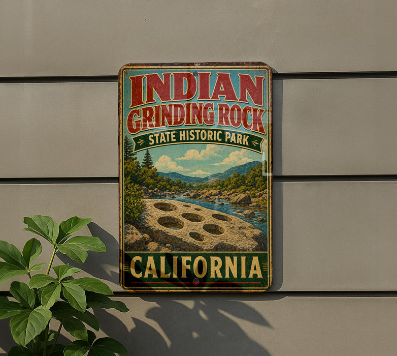A vintage-style sign for Indian Grinding Rock State Historic Park in California, featuring a scenic landscape with mountains, a river, and a large hole in the ground.
