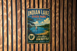 A vintage-style metal sign for Indian Lake State Park in Ohio, featuring a scenic image of a lake with a sailboat and a forested shoreline.
