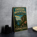 A vintage-style metal sign for Indian Mountain State Park in Tennessee, featuring a scenic landscape with mountains, trees, and a river.