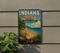 A vintage-style sign for Indiana Dunes State Park, featuring a beach scene with a lake and mountains in the background.