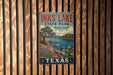 A vintage metal sign for Inks Lake State Park in Texas, featuring a scenic landscape with a lake, mountains, and cacti.