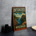 A vintage-style metal sign for Interstate State Park in Wisconsin, featuring a scenic landscape with a river and mountains.