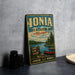A vintage-style metal sign for the Ionia State Recreation Area in Michigan, featuring a scenic image of a lake, pine trees, and a canoe.
