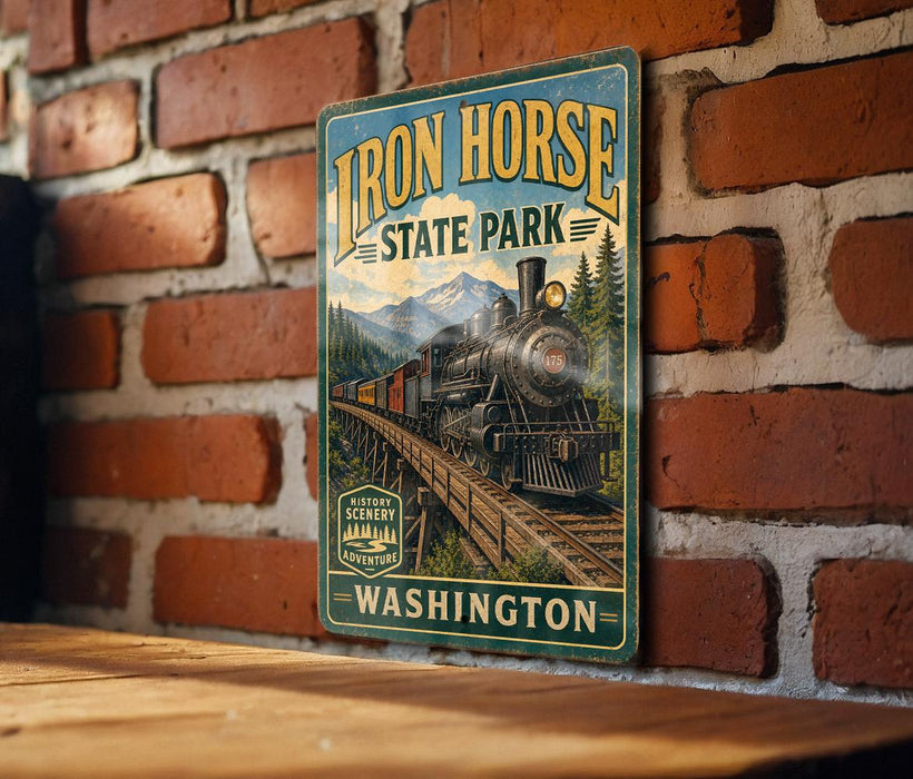 A vintage-style metal sign for Iron Horse State Park in Washington, featuring a train on a bridge and surrounded by mountains.