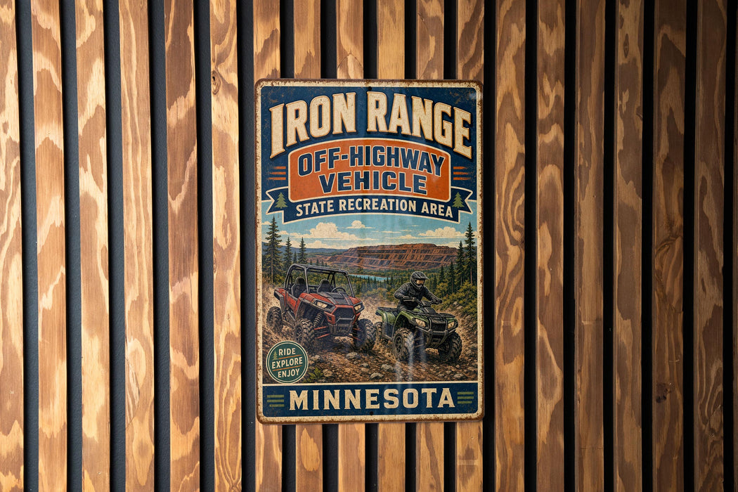 A vintage metal sign for the Iron Range Off-Highway Vehicle State Recreation Area in Minnesota, featuring an illustration of an ATV and a person riding it.