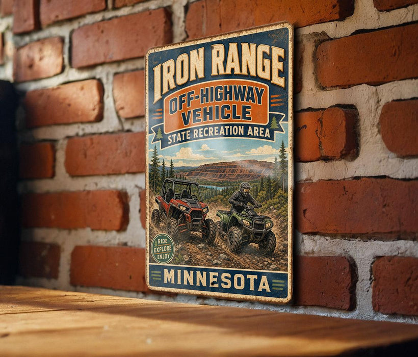A vintage-style sign for the Iron Range Off-Highway Vehicle Recreation Area in Minnesota, featuring an illustration of two off-road vehicles and a scenic landscape.