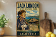 A vintage-style sign for Jack London's State Historic Park in California, featuring a portrait of a man and a dog, with a scenic landscape in the background.