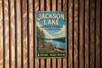 A vintage-style metal sign for Jackson Lake State Park in Ohio, featuring a scenic illustration of the lake and surrounding landscape.