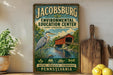 A vintage-style sign for the Jacobburg Environmental Education Center in Pennsylvania, featuring a blue heron and a red bridge.