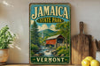 A vintage-style metal sign for Jamaica State Park in Vermont, featuring a scenic landscape with a covered bridge and mountains in the background.