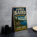 A vintage-style metal sign for James Baird State Park in New York, featuring a scenic landscape with a lake, mountains, and a sailboat.