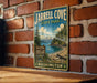 A vintage-style metal sign for Jarrell Cove State Park in Washington, featuring a scenic landscape with a mountain, pine trees, and a lake.