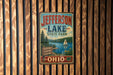 A vintage-style metal sign for Jefferson Lake State Park in Ohio, featuring a scenic illustration of the lake and surrounding landscape.