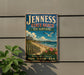 A vintage-style sign for Jenness State Beach in New Hampshire, featuring a beach scene with a lighthouse, palm trees, and a seagull.