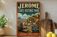 A vintage-style sign for Jerome State Historic Park in Arizona, featuring a scenic illustration of the town and mountains.