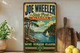 A vintage-style poster of Joe Wheeler State Park in Alabama, featuring a scenic landscape with a lake, trees, and a sailboat.