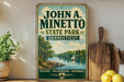 A vintage-style sign for John A. Minetto State Park in Connecticut, featuring a scenic lake and sailboat illustration.