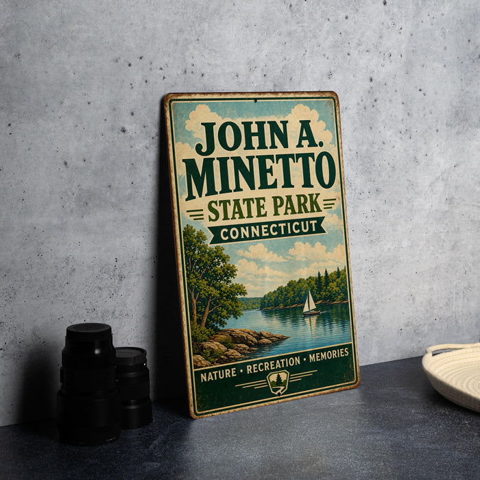 A vintage-style sign for John A. Minetto State Park in Connecticut, featuring a scenic landscape with a lake, trees, and a sailboat.
