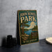 A vintage-style metal sign for John Hens Park in Wisconsin, featuring a scenic landscape with a lake and pine trees.