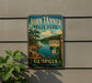 A vintage-style sign for John Tanner State Park in Georgia, featuring a scenic landscape with a lake and pine trees.