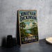 A vintage-style sign for Jonathan Dickinson State Park, featuring a scenic illustration of a tropical landscape with palm trees and a body of water.