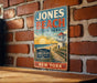 A vintage-style metal sign for Jones Beach State Park in New York, featuring a beach scene with a lighthouse and a welcome sign.