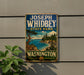 A vintage-style metal sign for Joseph Whidbey State Park in Washington, featuring a scenic landscape with a pine tree, a body of water, and mountains in the background.