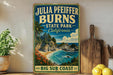 A vintage-style sign for Julia Pfeiffer Burns State Park in California, featuring a scenic coastal landscape with a waterfall and beach.