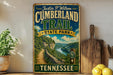 A vintage-style sign for the Cumberland Trail at Tennessee State Park, featuring a scenic mountain landscape with a winding path.