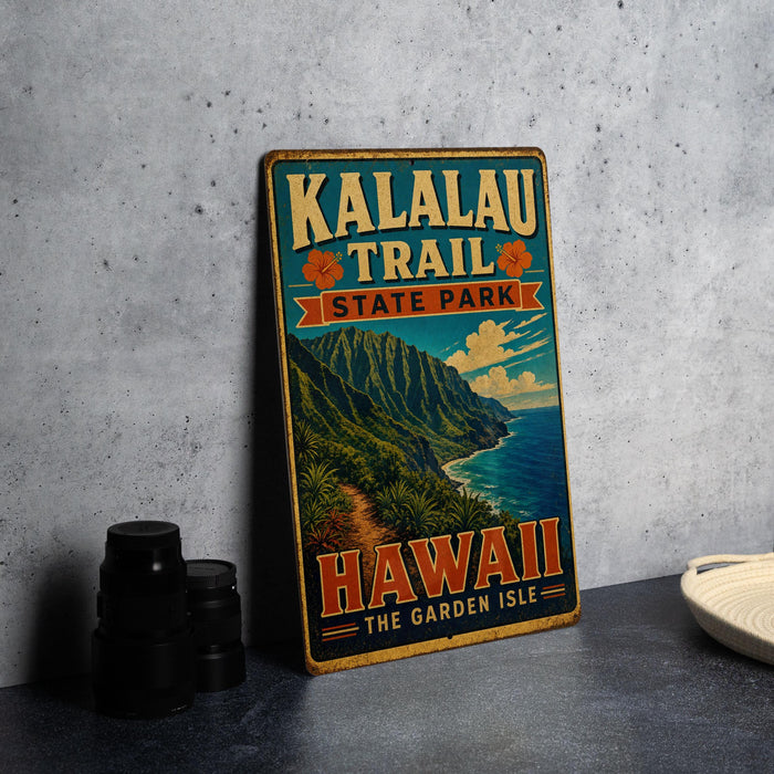 A vintage-style metal sign for Kalalau Trail State Park in Hawaii, featuring a mountainous landscape and the text "Hawaii The Garden Isle".